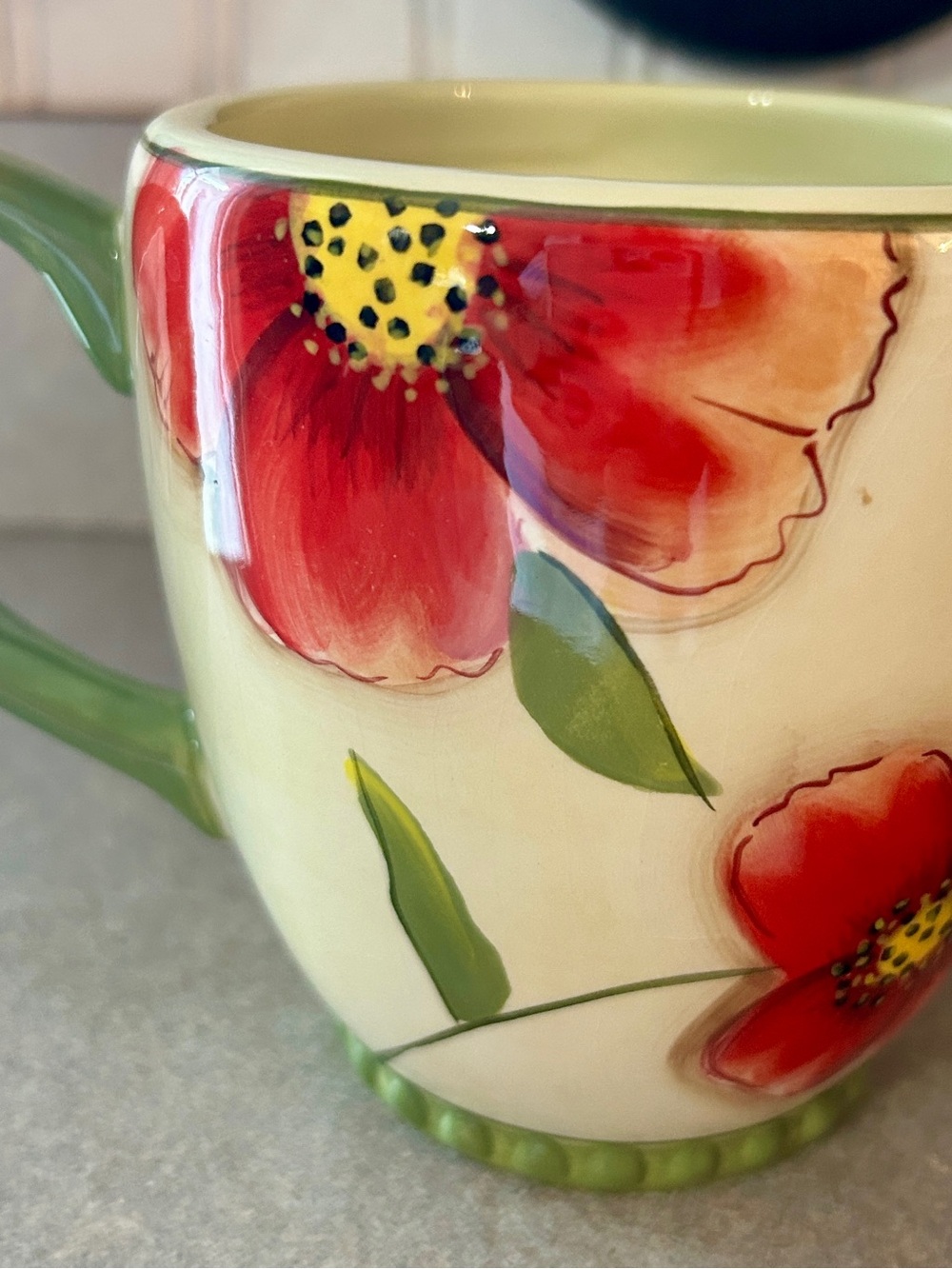 Cream Ceramic Coffee Mug with Red Floral Design and Green Handle